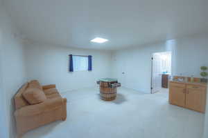 Living area featuring sink and light colored carpet