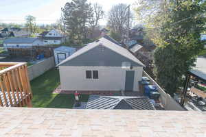 Rear view of house featuring a patio and a storage shed