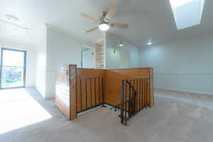 Corridor featuring carpet and crown molding