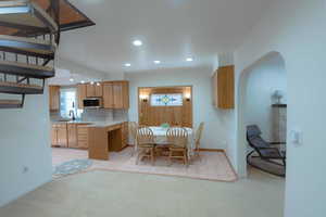 Unfurnished dining area featuring light carpet and sink