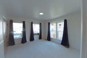 Empty room with light colored carpet