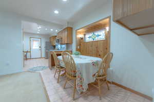 Dining space featuring light tile patterned flooring