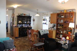 Dining area with ceiling fan and vaulted ceiling