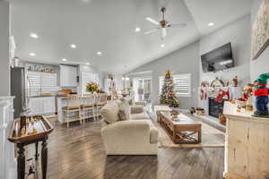 Living room featuring dark hardwood / wood-style floors, ceiling fan, sink, and high vaulted ceiling