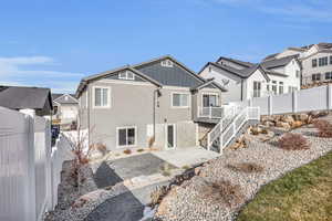 Rear view of house featuring a patio and a wooden deck