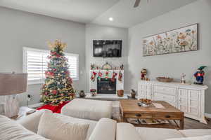 Living room with hardwood / wood-style flooring and ceiling fan