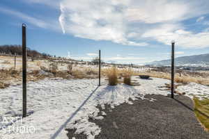 Yard covered in snow with a mountain view