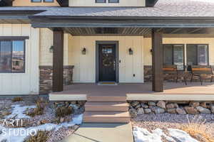 View of exterior entry featuring a porch