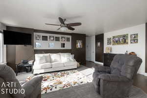 Living room featuring ceiling fan and light hardwood / wood-style floors