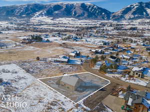 Snowy aerial view featuring a mountain view