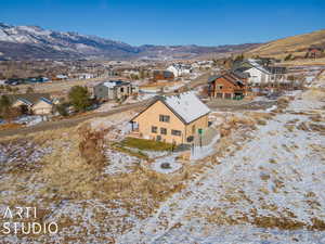 Snowy aerial view featuring a mountain view