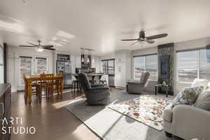 Living room featuring dark hardwood / wood-style floors and ceiling fan