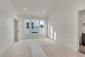 Primary bedroom with vaulted ceiling, walk-in closet and en-suite bathroom