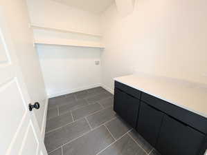 Laundry room featuring cabinets and shelving