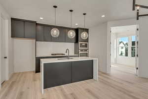 Upgraded kitchen with quartz waterfall countertop and quartz backsplash