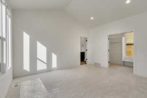 Primary bedroom with vaulted ceiling, walk-in closet and en-suite bathroom