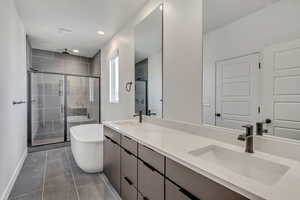 Primary bathroom, double sinks, double shower head and stand-alone soaker tub