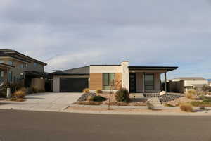 View of front of property featuring a porch and a garage