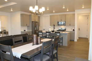 Dining area with a chandelier and dark hardwood / wood-style flooring