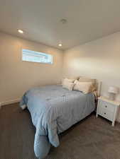 Bedroom with dark colored carpet