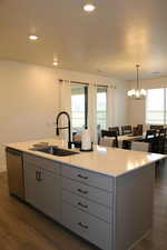 Kitchen with gray cabinetry, sink, dishwasher, dark hardwood / wood-style floors, and plenty of natural light