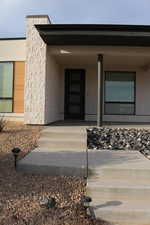 Doorway to property featuring a porch