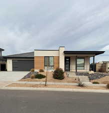 View of front facade with a porch and a garage