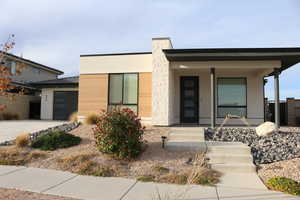 Modern home featuring a porch and a garage