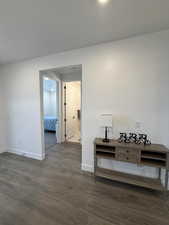 Hallway with dark wood-type flooring