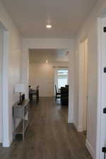 Hallway with dark hardwood / wood-style floors