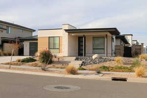 View of front of house featuring a porch and a garage