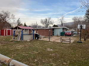 View of yard featuring a mountain view and a storage unit