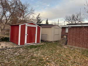 View of outdoor structure with a lawn