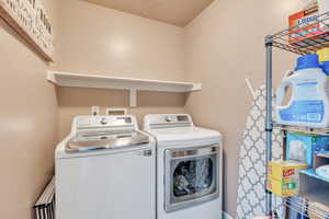 Laundry area with washer and clothes dryer