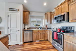 Kitchen featuring sink, stainless steel appliances, and hardwood / wood-style flooring