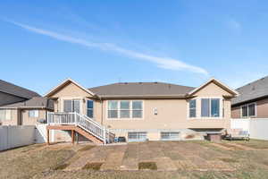 Rear view of property with a lawn