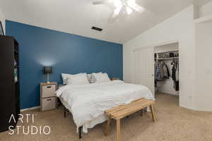 Bedroom featuring carpet, ceiling fan, vaulted ceiling, and a closet