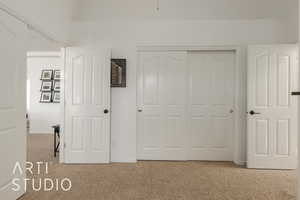 Unfurnished bedroom with light colored carpet and a closet