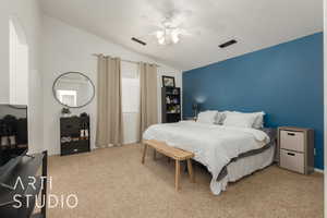 Carpeted bedroom featuring vaulted ceiling and ceiling fan