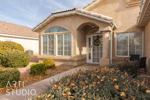 Doorway to property featuring central air condition unit