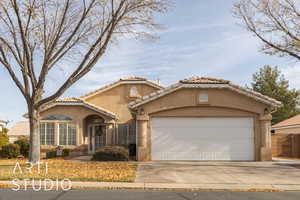 Mediterranean / spanish house featuring a garage