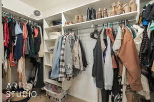 Walk in closet featuring carpet floors