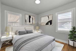 Virtually staged bedroom featuring hardwood / wood-style flooring