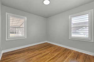 Unfurnished bedroom featuring hardwood / wood-style floors