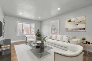 Virtually staged living room featuring hardwood / wood-style floors and a textured ceiling