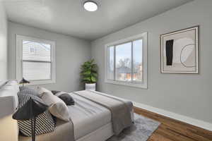 Virtually staged bedroom with hardwood / wood-style floors