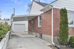 View of side of home with a carport