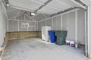 Garage featuring freezer and a garage door opener