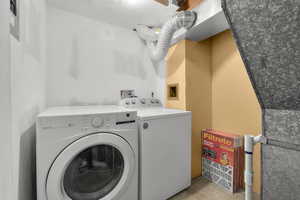 Laundry room featuring separate washer and dryer