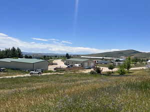 View of yard featuring a mountain view and an outdoor structure